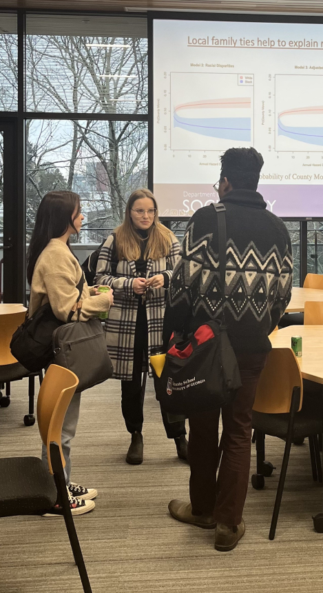 Graduate students meeting after a guest speaker
